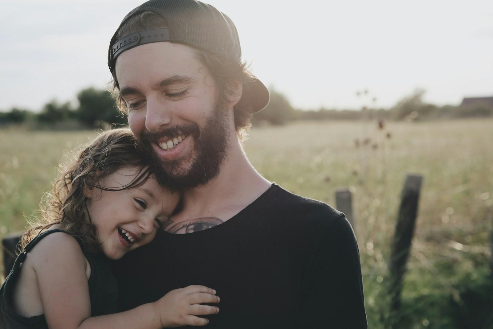 Parent carrying child, representing fostering and family care