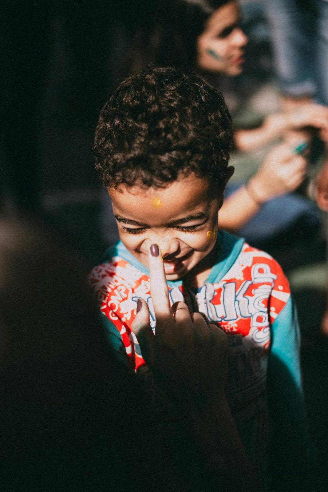 A young child getting their face painted